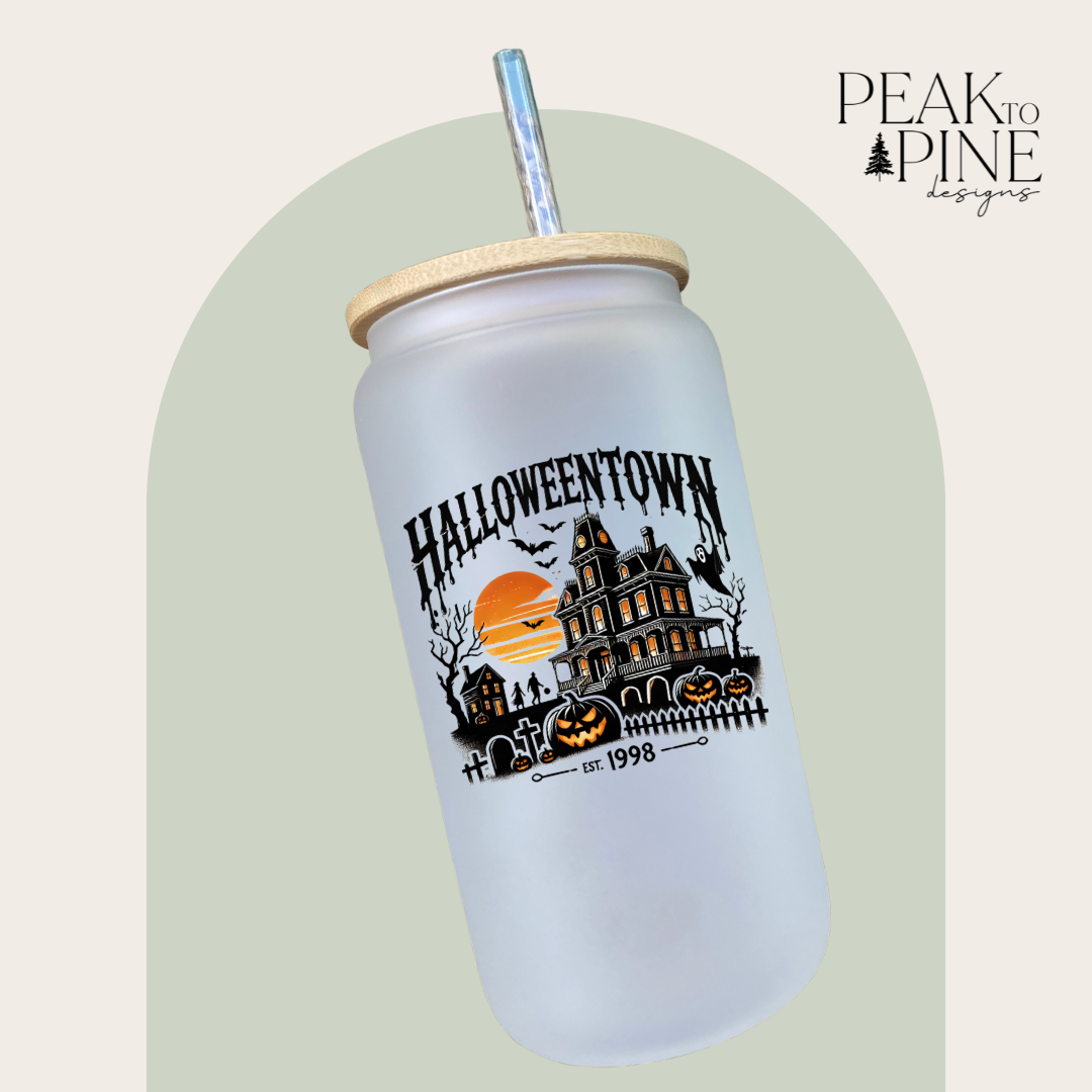 Eco friendly glass tumbler with lid and straw featuring a spooky Halloweentown design perfect for Halloween and fall season